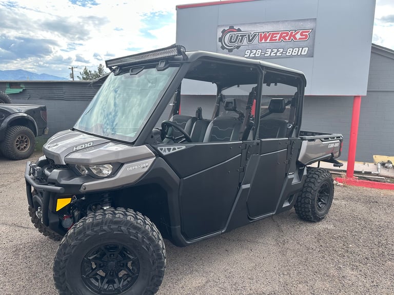 Black four-seater utility vehicle with large tires parked in front of City Werks business building