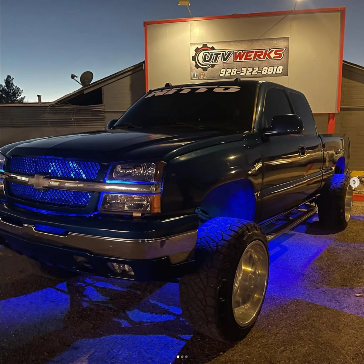 Black Chevrolet Silverado with blue underglow