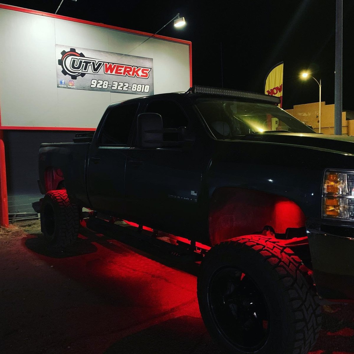 Black pickup truck with red underglow