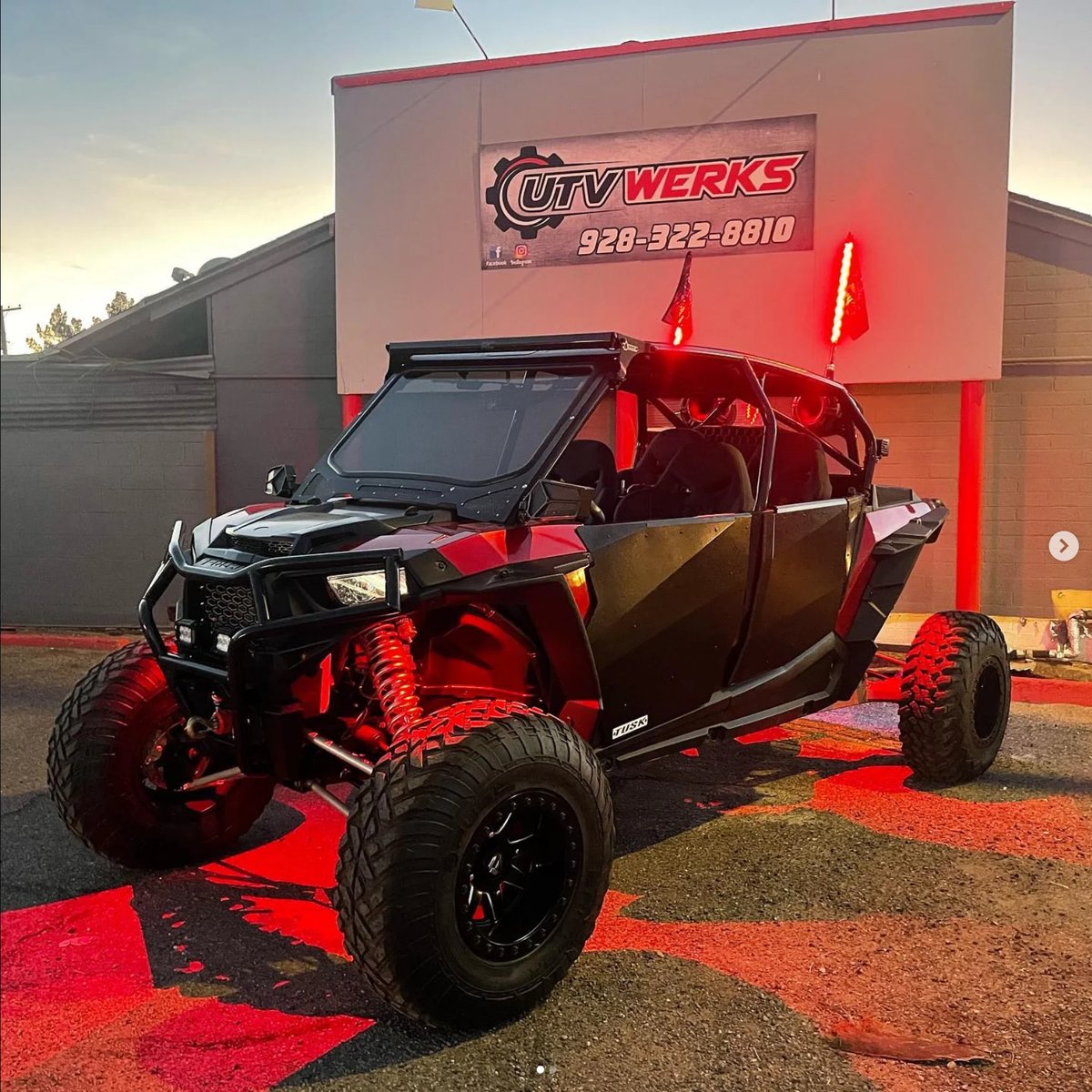 Red and black modified UTV with neon lighting